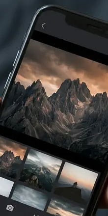 Smartphone screen showing a photography gallery app with a dramatic landscape mountain photo, dark UI design